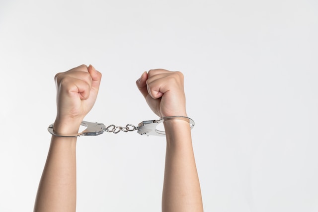 person with hands in handcuffs